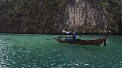 People in boat sailing on sea