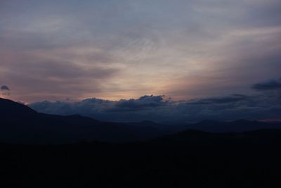 Scenic view of silhouette mountains against sky during sunset