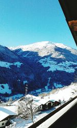 Scenic view of snowcapped mountains against blue sky