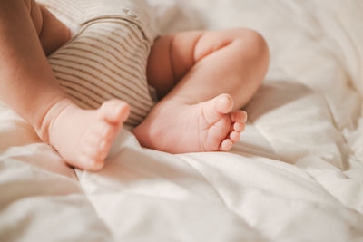 Baby boy lying on bed