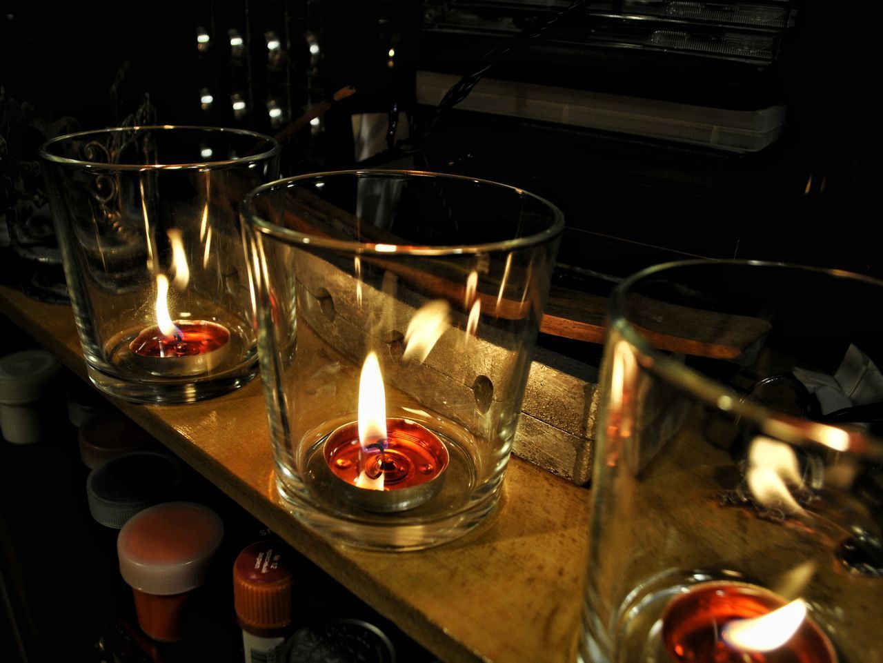 CLOSE-UP OF LIT CANDLES IN TEMPLE