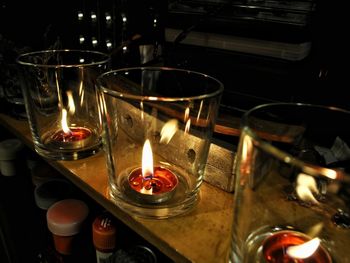 Close-up of lit tea light candles in temple