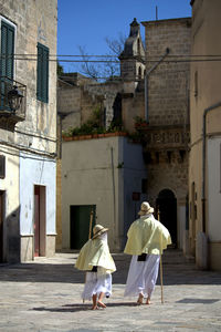 Rear view of woman standing in city