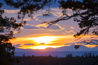 Scenic view of silhouette mountains against sky at sunset