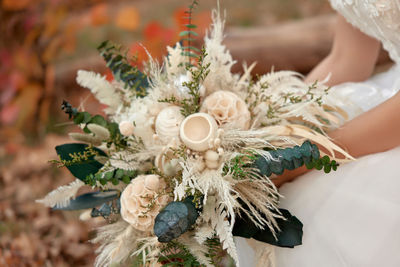 Midsection of woman holding bouquet