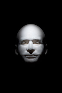 Close-up of human face against black background
