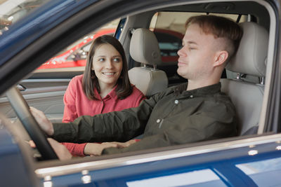 Portrait of smiling couple sitting in car