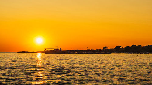 Scenic view of sea against orange sky