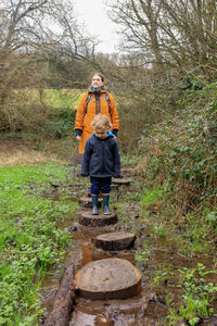 Rear view of woman walking on footpath