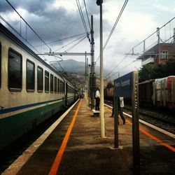 Train at railroad station against sky