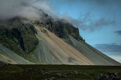 Scenic view of mountains against cloudy sky