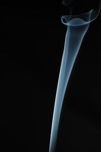 Close-up of illuminated lamp against black background