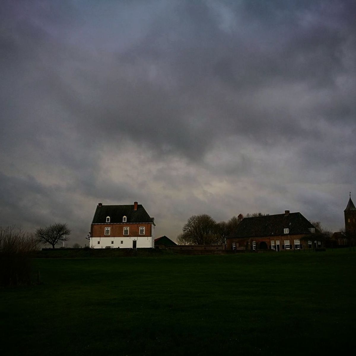 built structure, architecture, house, building exterior, grass, cloud - sky, sky, storm cloud, field, country house, no people, tree, barn, landscape, tranquility, residential building, outdoors, nature, detached house, farmhouse, day, thunderstorm, beauty in nature