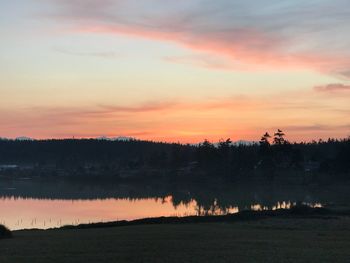 Scenic view of lake against romantic sky at sunset