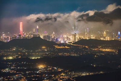 Illuminated cityscape against sky at night