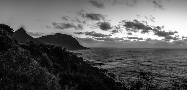 View of calm sea against mountain range