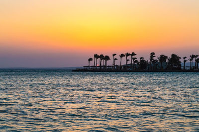 Scenic view of sea against orange sky