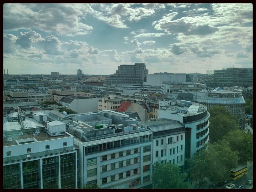 transfer print, building exterior, architecture, built structure, auto post production filter, city, sky, residential building, residential structure, high angle view, cityscape, residential district, cloud - sky, house, roof, crowded, building, day, city life, cloud