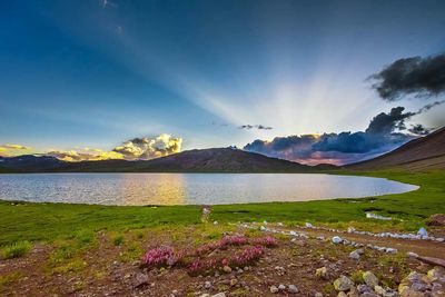 Scenic view of sea and mountains against sky