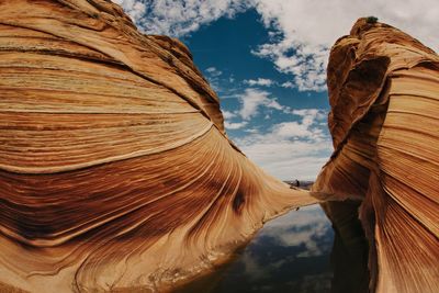 Low angle view of rock formation against sky