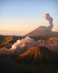 Volcanic landscape against sky during sunset