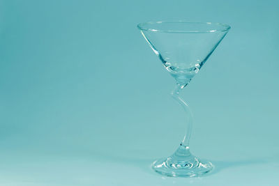 Close-up of glass of water against blue background