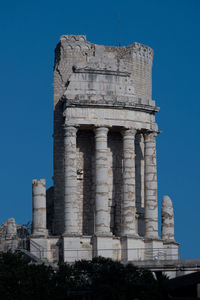 Low angle view of historic building against blue sky