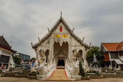 View of temple building against cloudy sky