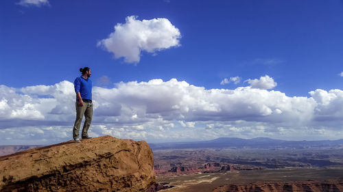 Full length of man standing on cliff against sky