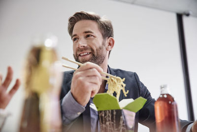 Businessman having lunch break with asian food