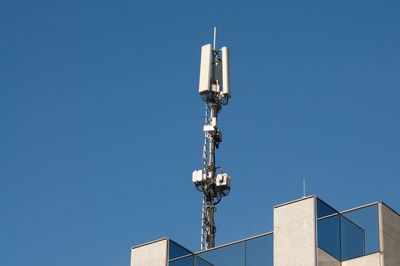 Low angle view of communications tower against clear sky