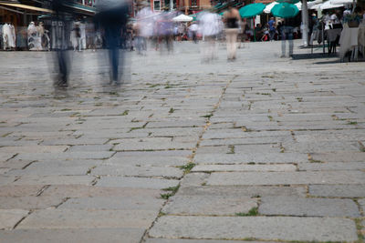 People walking on sidewalk in city