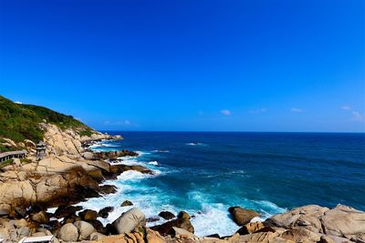 Scenic view of sea against blue sky