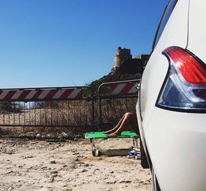 Man in car against clear sky