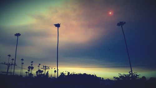 Low angle view of street light against sky at dusk