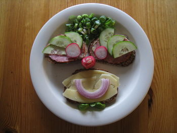 High angle view of anthropomorphic face made from bread and vegetables