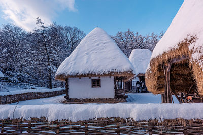 Traditional romanian village in transylvania with old house straw roofing covered with snow 