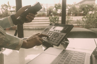 Midsection of man using mobile phone