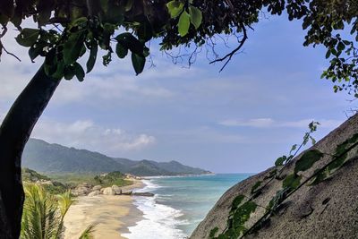 Scenic view of sea and mountains against sky