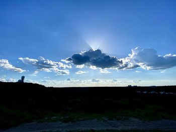 Scenic view of silhouette landscape against blue sky