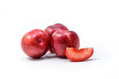 Close-up of red cherries over white background