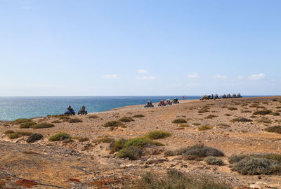Scenic view of beach against clear blue sky