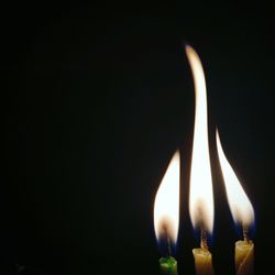 Close-up of illuminated lamp against black background