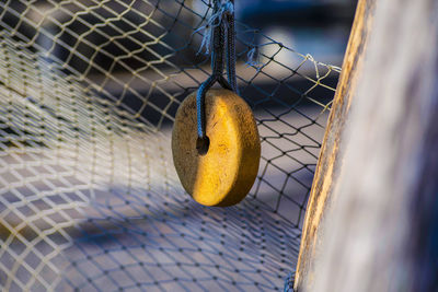 Close-up of rope hanging on chainlink fence