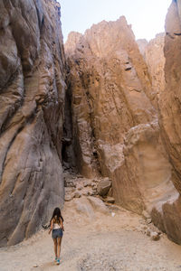 Young lady walking in the weshwash valley, south sinai mountain desert