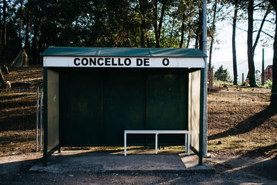 Empty bench by fence