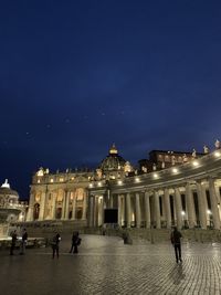 People in front of building at night