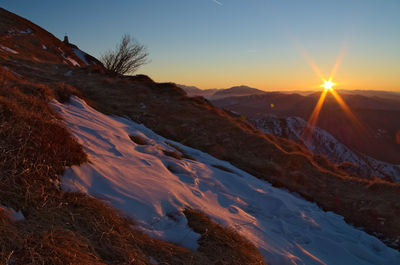 Scenic view of mountains against sky during sunset