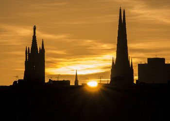 Silhouette of building at sunset