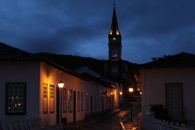 Illuminated buildings against sky at night